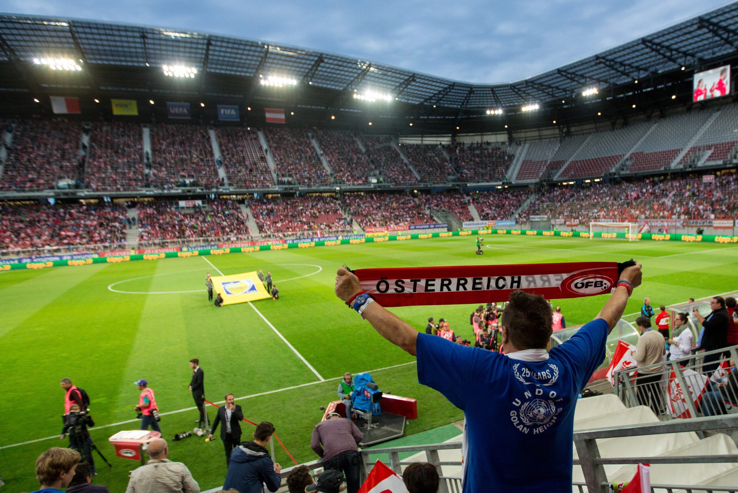 KLAGENFURT,AUSTRIA,31.MAY.16 - SOCCER - UEFA European Championship 2016 in France, OEFB international match, friendly match, Austria vs Malta. Image shows a fan with a scarf and a general view of the Woerthersee Stadium.
